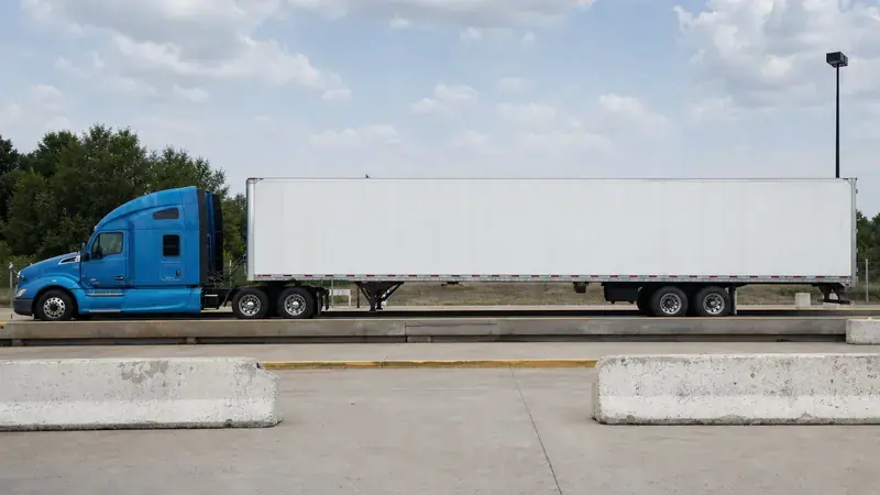 A semi-truck parked on a truck-stop scale