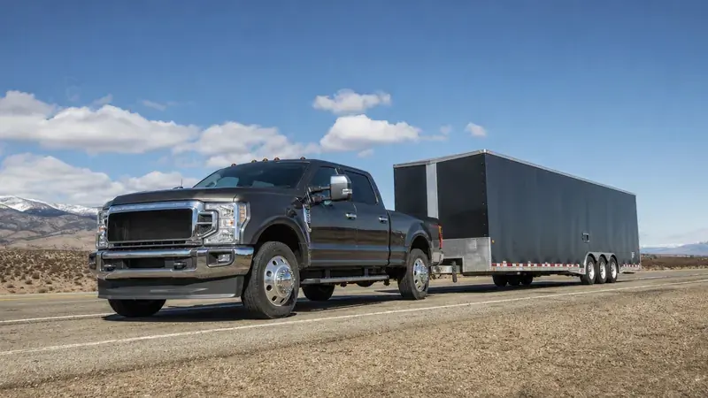 A heavy-duty pickup towing an enclosed cargo trailer