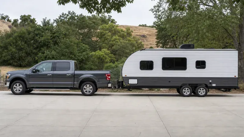 A pickup towing a travel trailer, seen side-on