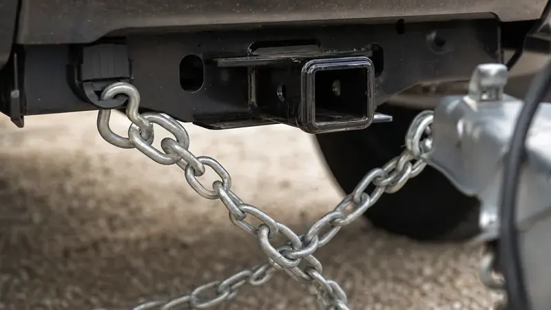 Safety chains hanging from a pickup's receiver hitch