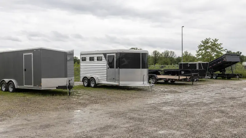 Cargo, horse and utility trailers parked on gravel
